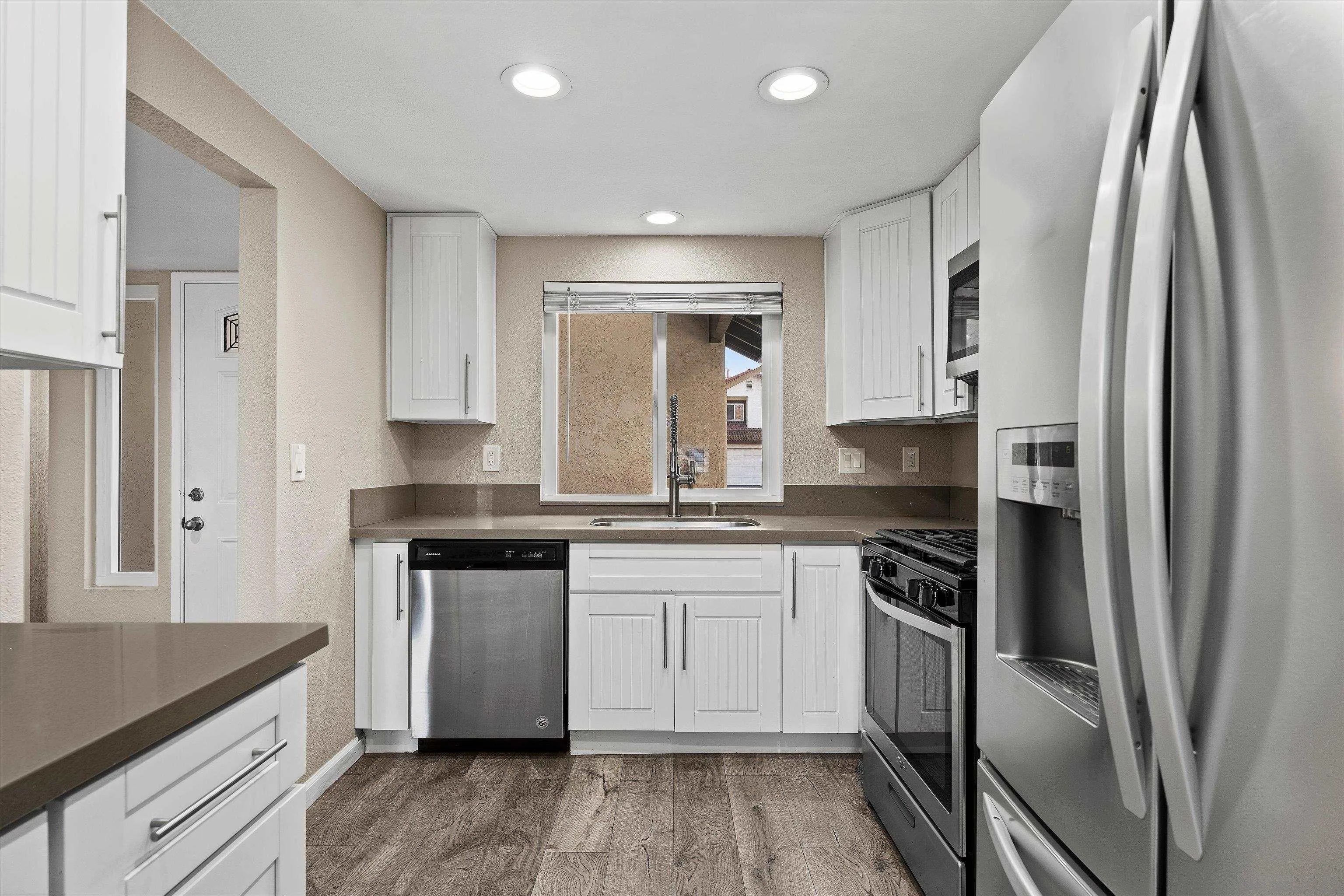5636 Boot Way Oceanside, CA 92057 - Photo 5 of 36 a kitchen with stainless steel appliances granite countertop a stove a sink and a refrigerator