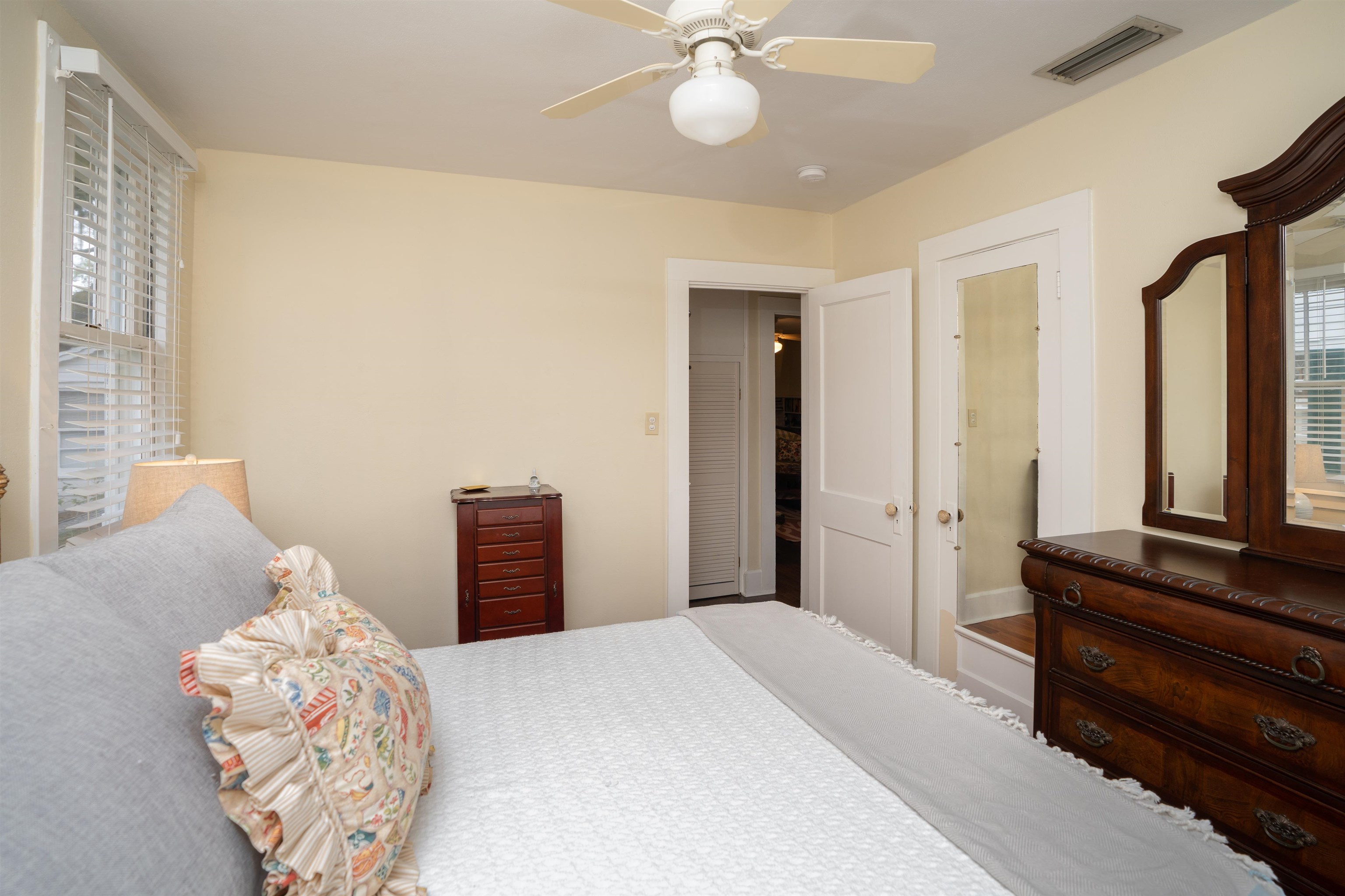 237 Rainey Avenue St. Augustine, FL 32084 - Photo 17 of 26 a bedroom with a bed and a chandelier