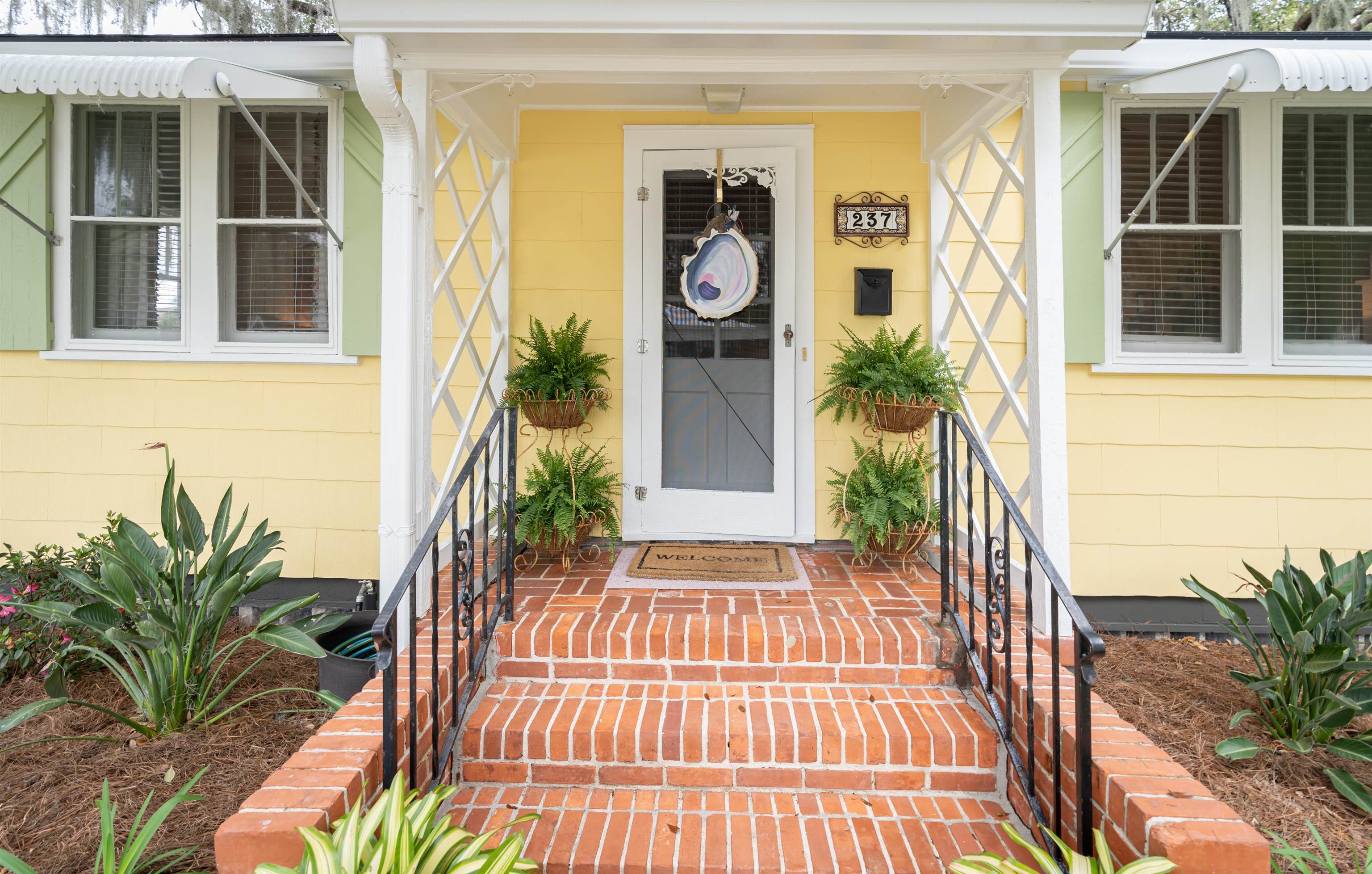237 Rainey Avenue St. Augustine, FL 32084 - Photo 3 of 26 a view of front door of house with potted plants