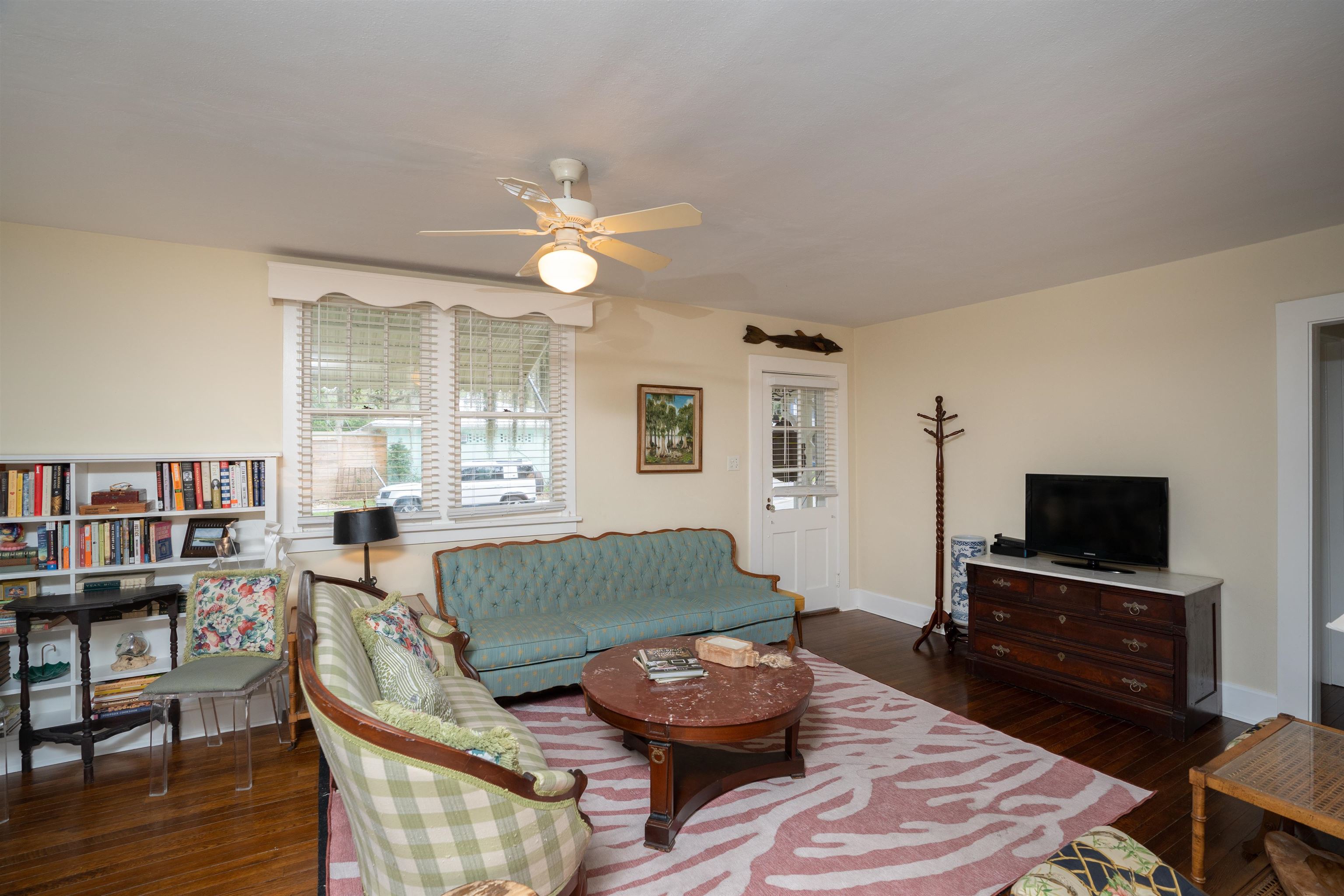 237 Rainey Avenue St. Augustine, FL 32084 - Photo 5 of 26 a living room with furniture a wooden floor and a flat screen tv