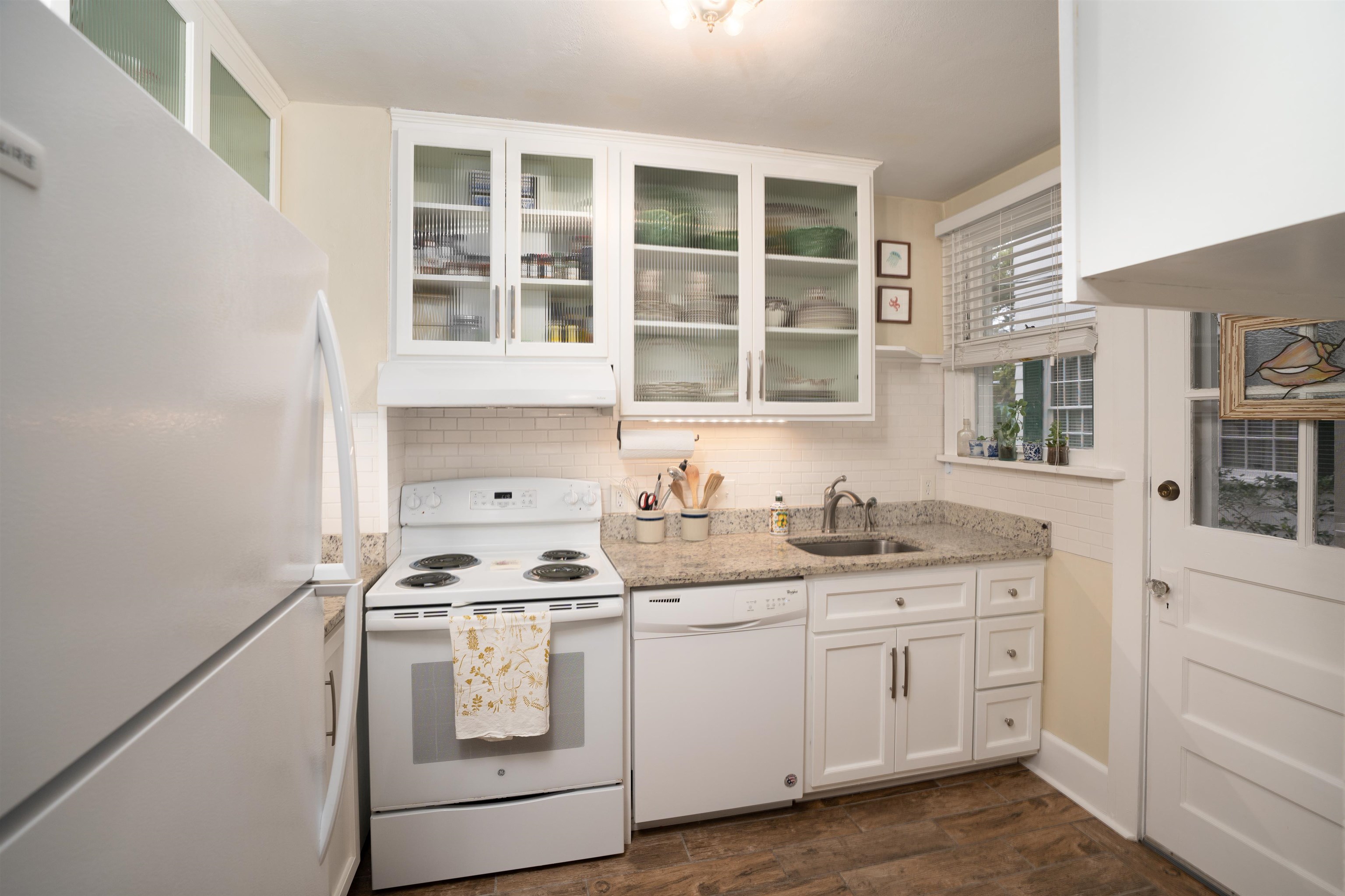 237 Rainey Avenue St. Augustine, FL 32084 - Photo 9 of 26 a kitchen with granite countertop white cabinets and sink stove