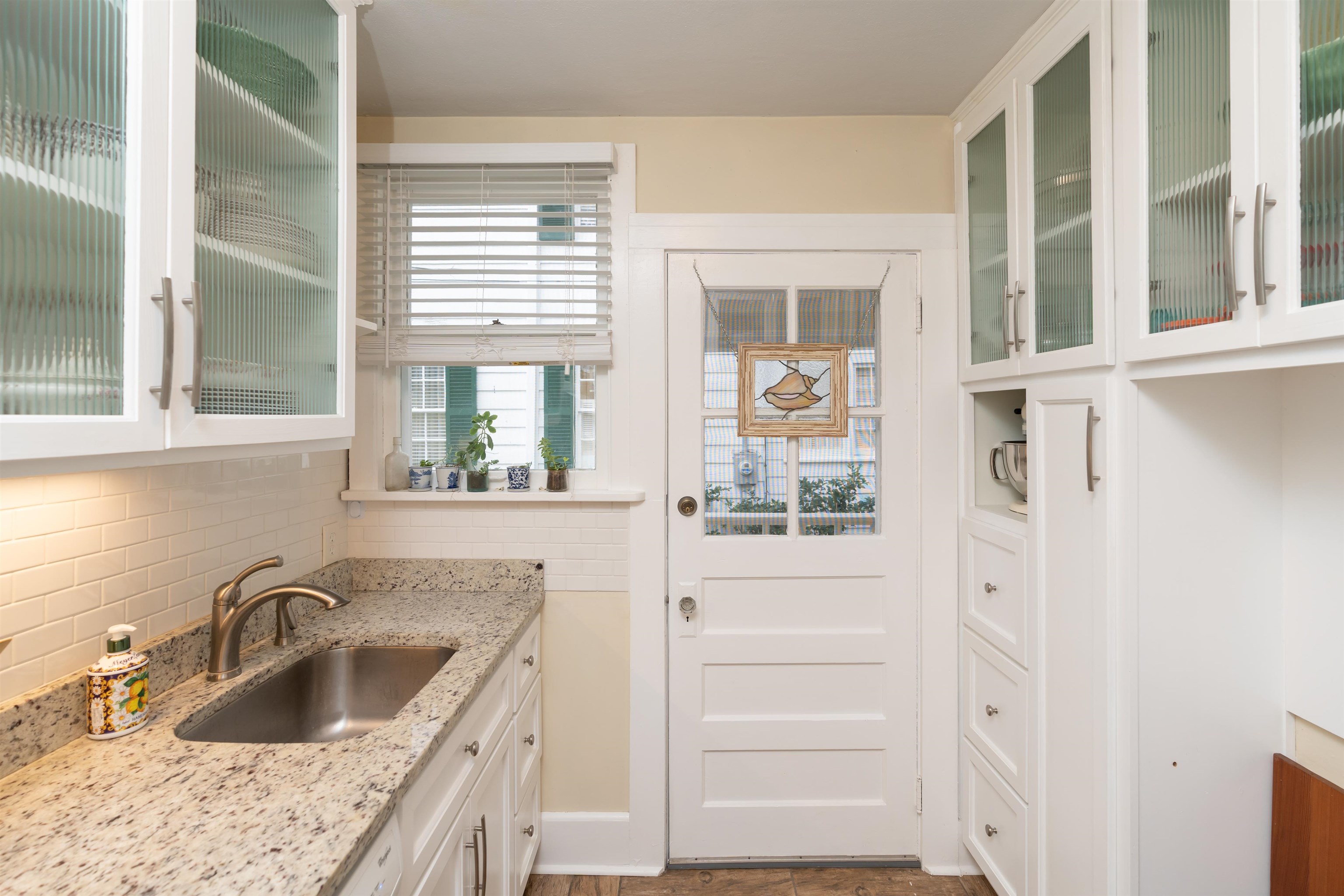 237 Rainey Avenue St. Augustine, FL 32084 - Photo 10 of 26 a kitchen with granite countertop a sink and a window