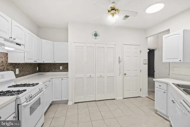 an empty room with window and a ceiling fan
