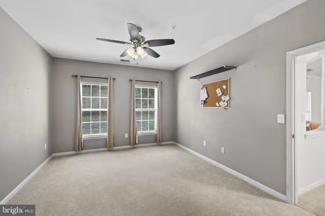 a view of walk in closet with clothes