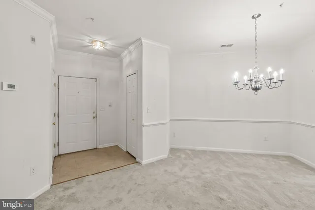 a view of a chandelier fan and entryway