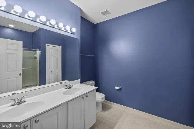 a bathroom with a sink vanity and a mirror