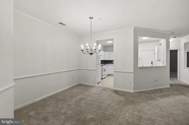 a view of a livingroom with furniture and a chandelier