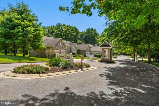 a view of a white house with a yard covered with snow