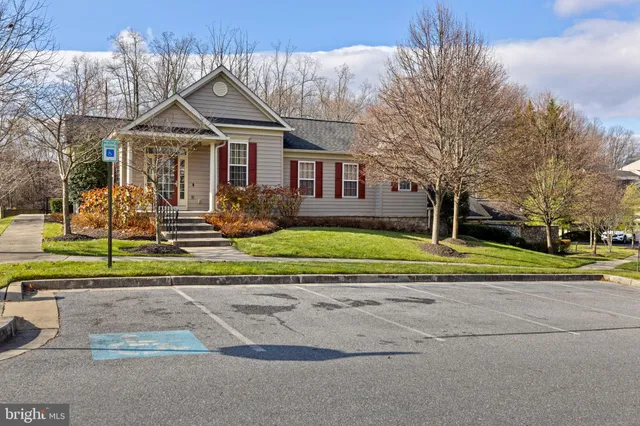a view of a large white house with a yard