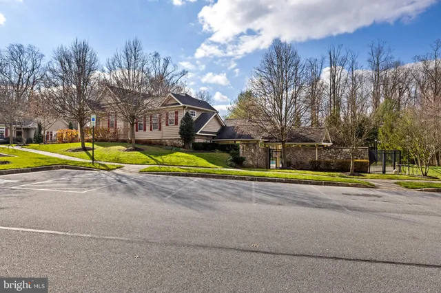 a view of a swimming pool with a table and chairs under an umbrella