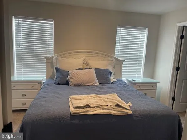 a bedroom with a bed and window