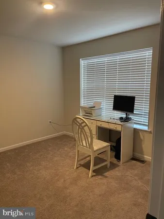 a workspace with furniture and a window