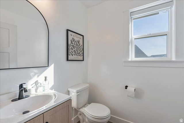 882 Spring Dew Lane Lehi, UT 84048 - Photo 30 of 46 Half bathroom featuring vanity and toilet
