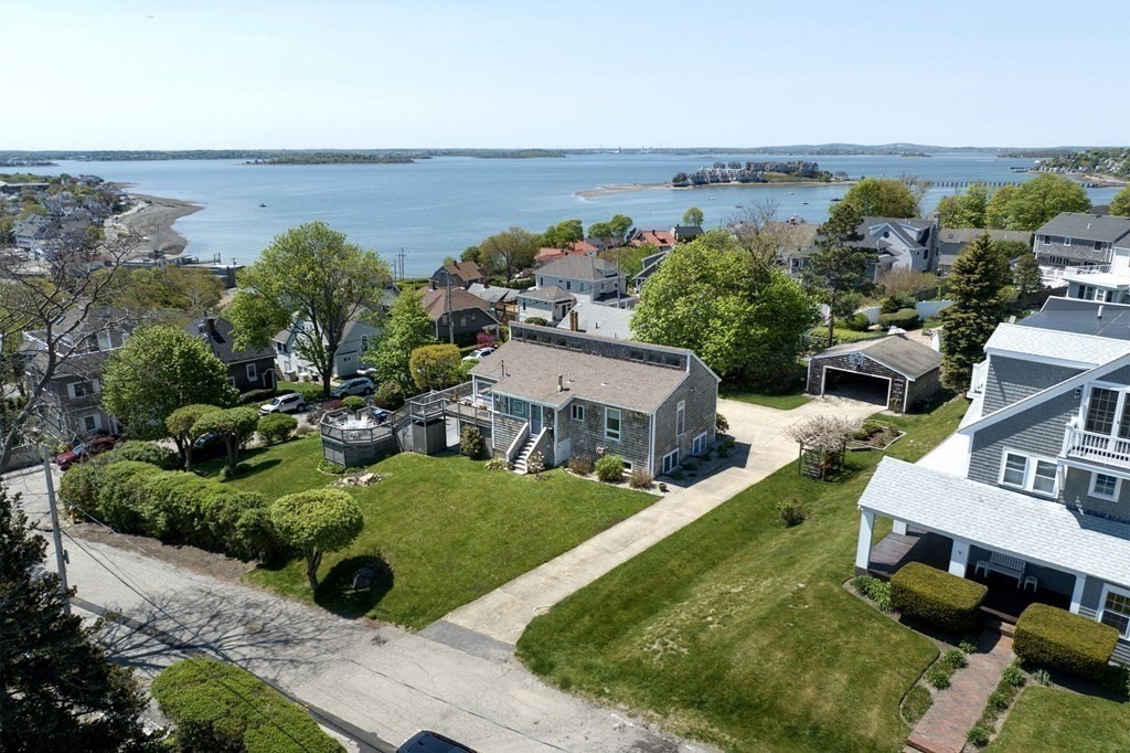 an aerial view of a house with garden space and ocean view