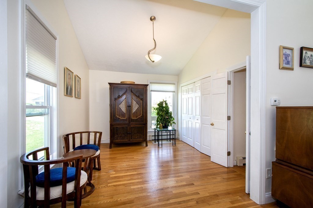 7 Bluff Road Hull, MA 02045 - Photo 20 of 35 a view of a livingroom with furniture wooden floor windows and a chandelier