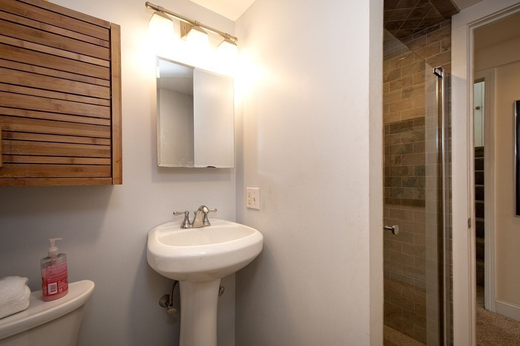 7 Bluff Road Hull, MA 02045 - Photo 25 of 35 a bathroom with a sink and a mirror