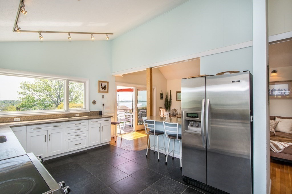 7 Bluff Road Hull, MA 02045 - Photo 7 of 35 a kitchen with granite countertop a refrigerator and a sink