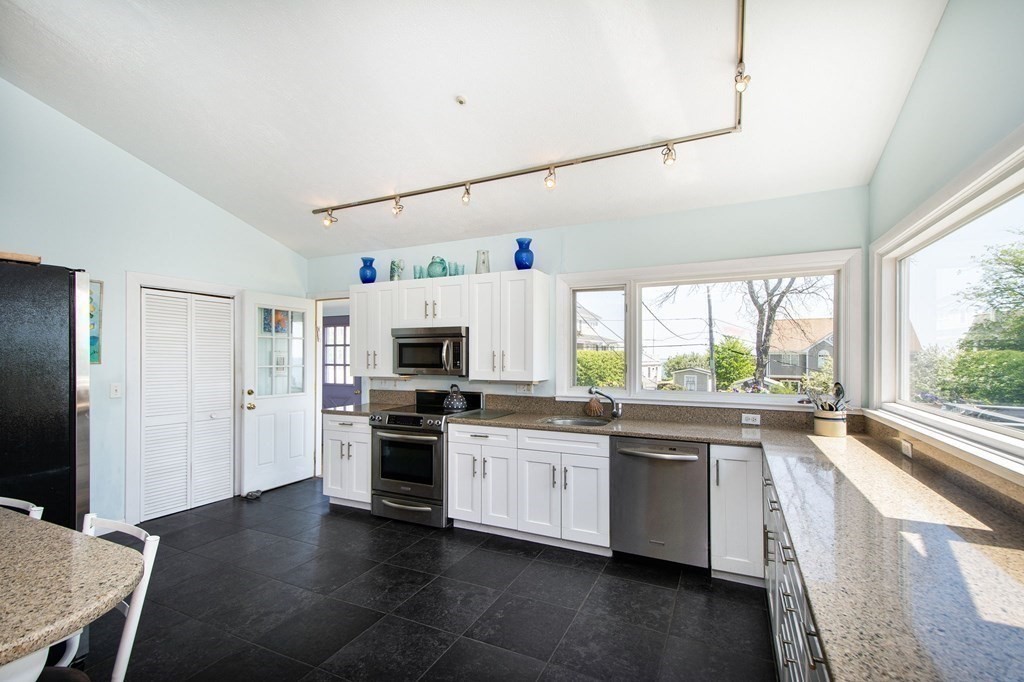 7 Bluff Road Hull, MA 02045 - Photo 8 of 35 a kitchen with stainless steel appliances granite countertop a stove and cabinets
