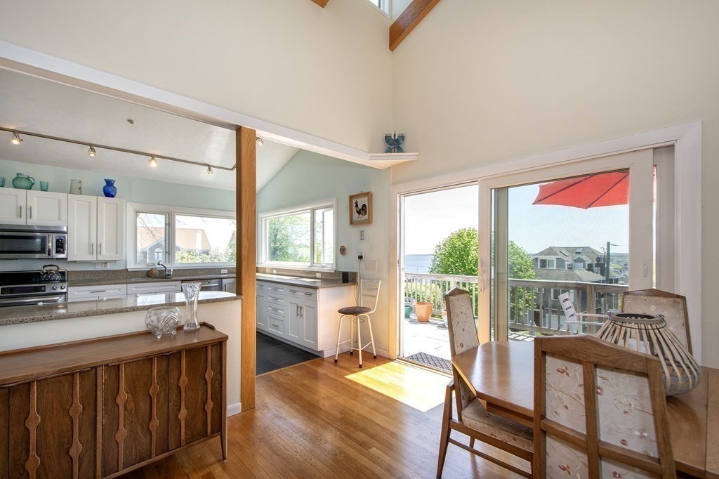 7 Bluff Road Hull, MA 02045 - Photo 10 of 35 a kitchen with stainless steel appliances granite countertop a stove a refrigerator a oven with white cabinets and wooden floor
