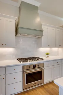 a kitchen with granite countertop a stove and a sink