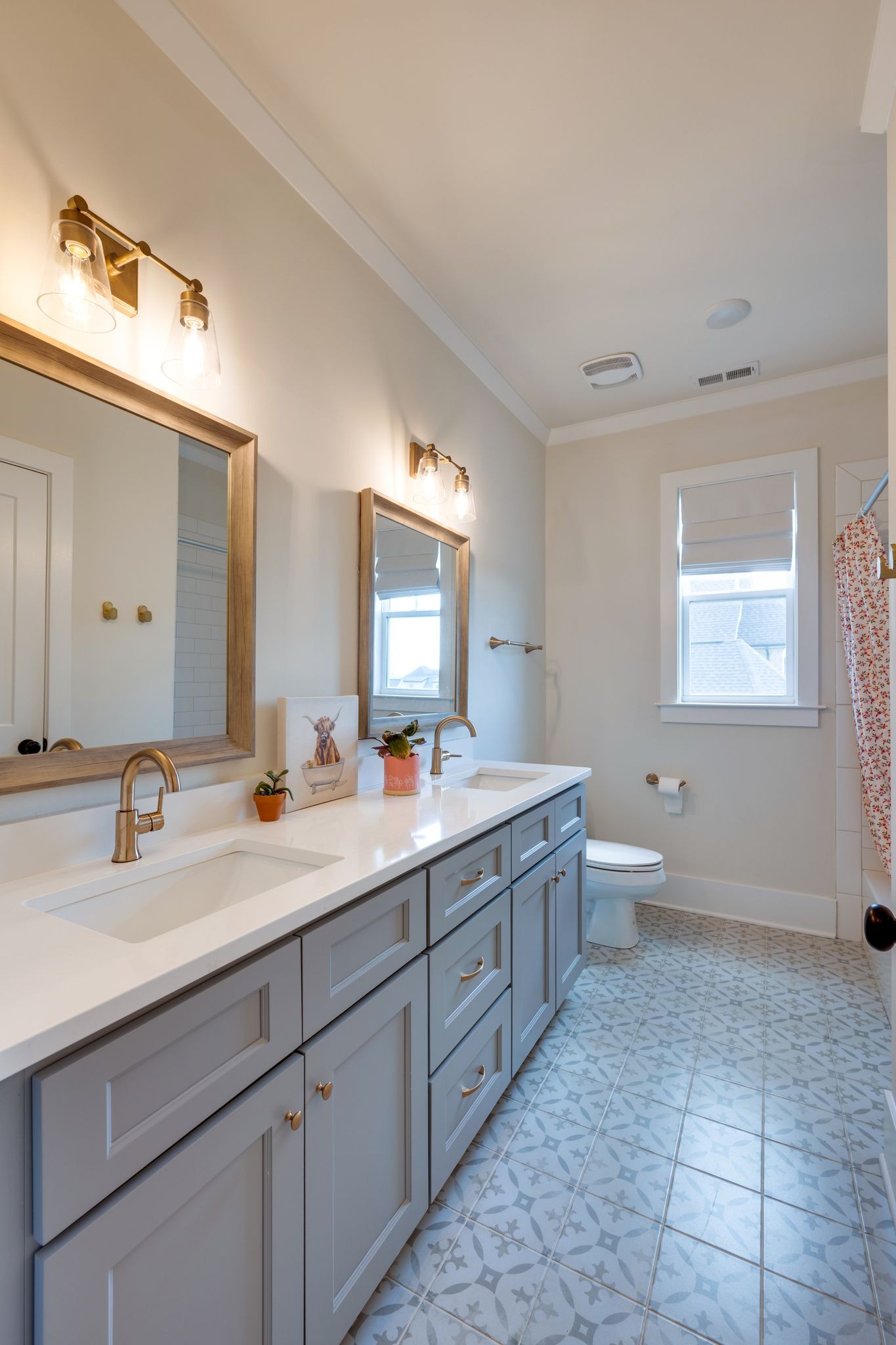 9011 Safehaven Place Spring Hill, TN 37174 - Photo 41 of 49 a bathroom with a double vanity sink toilet and mirror