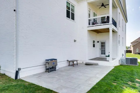 a view of a patio with table and chairs