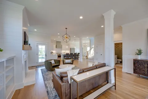 a living room with furniture a wooden floor and a fireplace