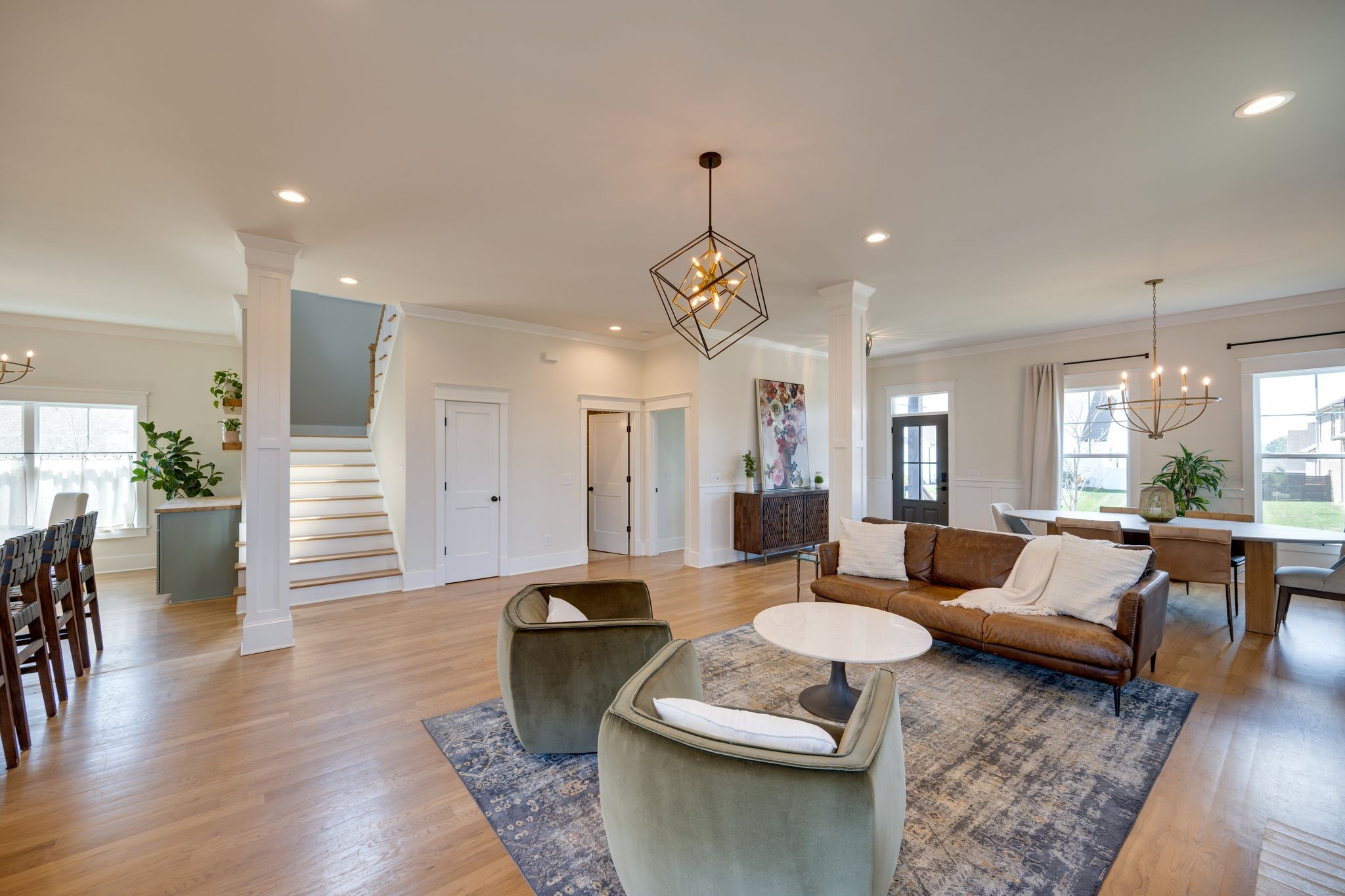 9011 Safehaven Place Spring Hill, TN 37174 - Photo 10 of 49 a living room with furniture a rug and a chandelier