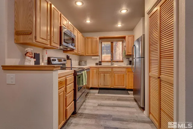 a kitchen with stainless steel appliances granite countertop a sink and cabinets