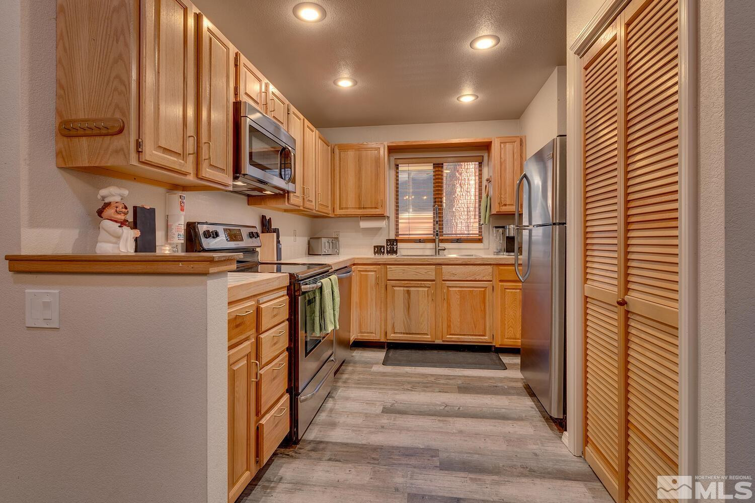931 Incline Way, Unit 249 MCCLOUD Incline Village, NV 89451 - Photo 15 of 21 a kitchen with stainless steel appliances granite countertop a sink and cabinets
