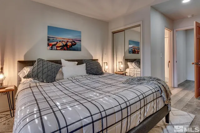 a bedroom with a bed and a painting on the wall