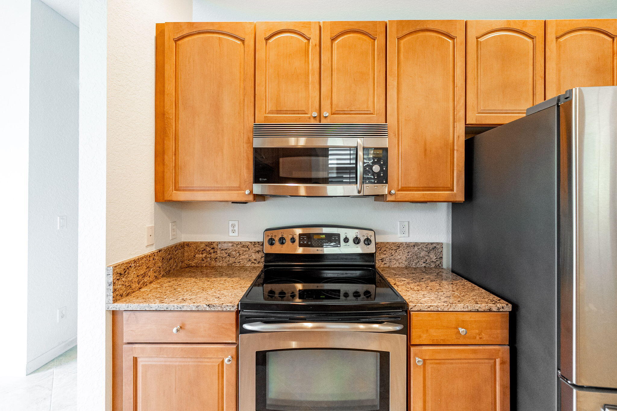 6675 Southeast Woodmill Pond Lane Stuart, FL 34997 - Photo 12 of 61 a stove top oven sitting inside of a kitchen