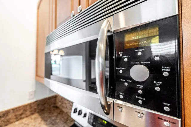 a kitchen with stainless steel appliances granite countertop a refrigerator and a stove