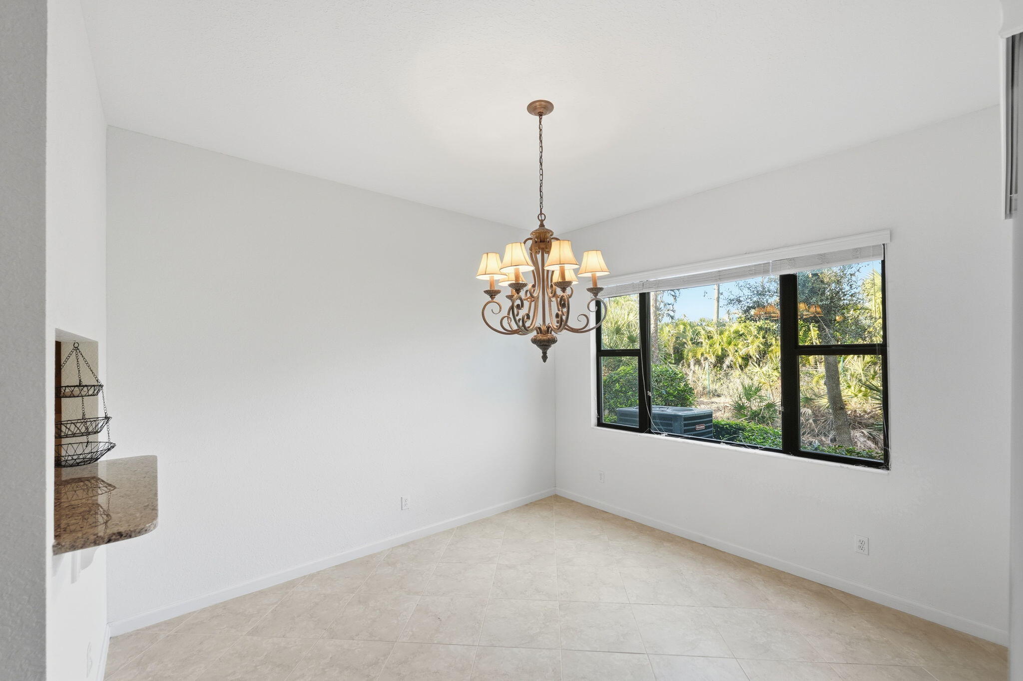 6675 Southeast Woodmill Pond Lane Stuart, FL 34997 - Photo 15 of 61 a view of a room with windows and chandelier