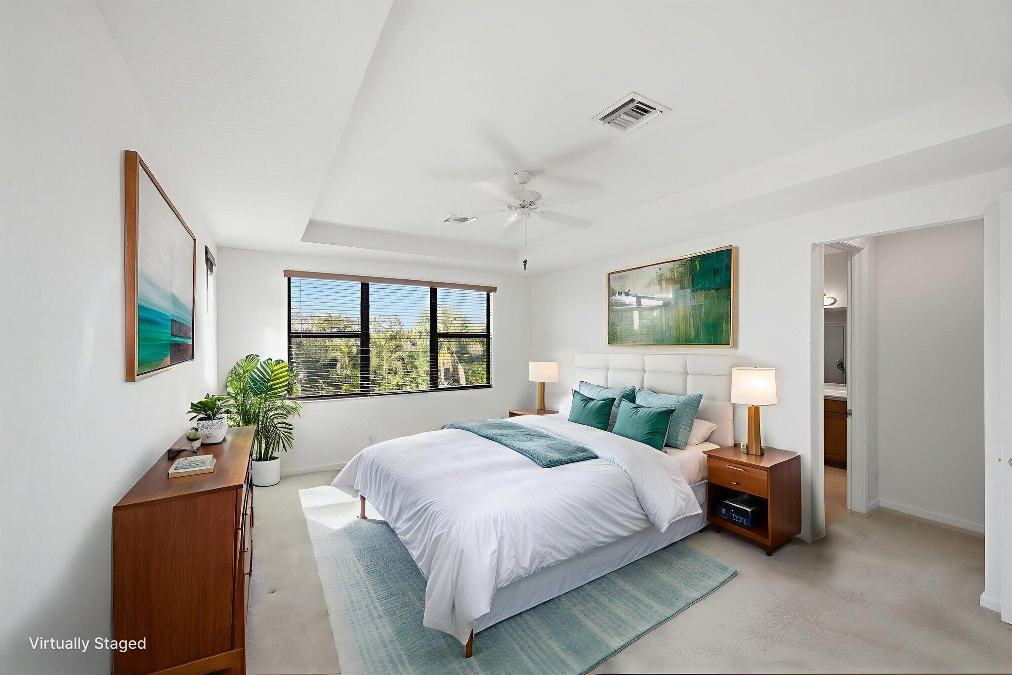 6675 Southeast Woodmill Pond Lane Stuart, FL 34997 - Photo 24 of 61 a bedroom with a large bed and a chandelier