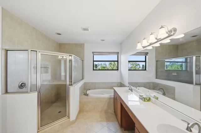 a bathroom with a double vanity sink and a mirror