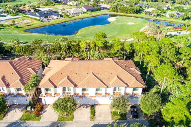 an aerial view of residential houses with outdoor space and swimming pool