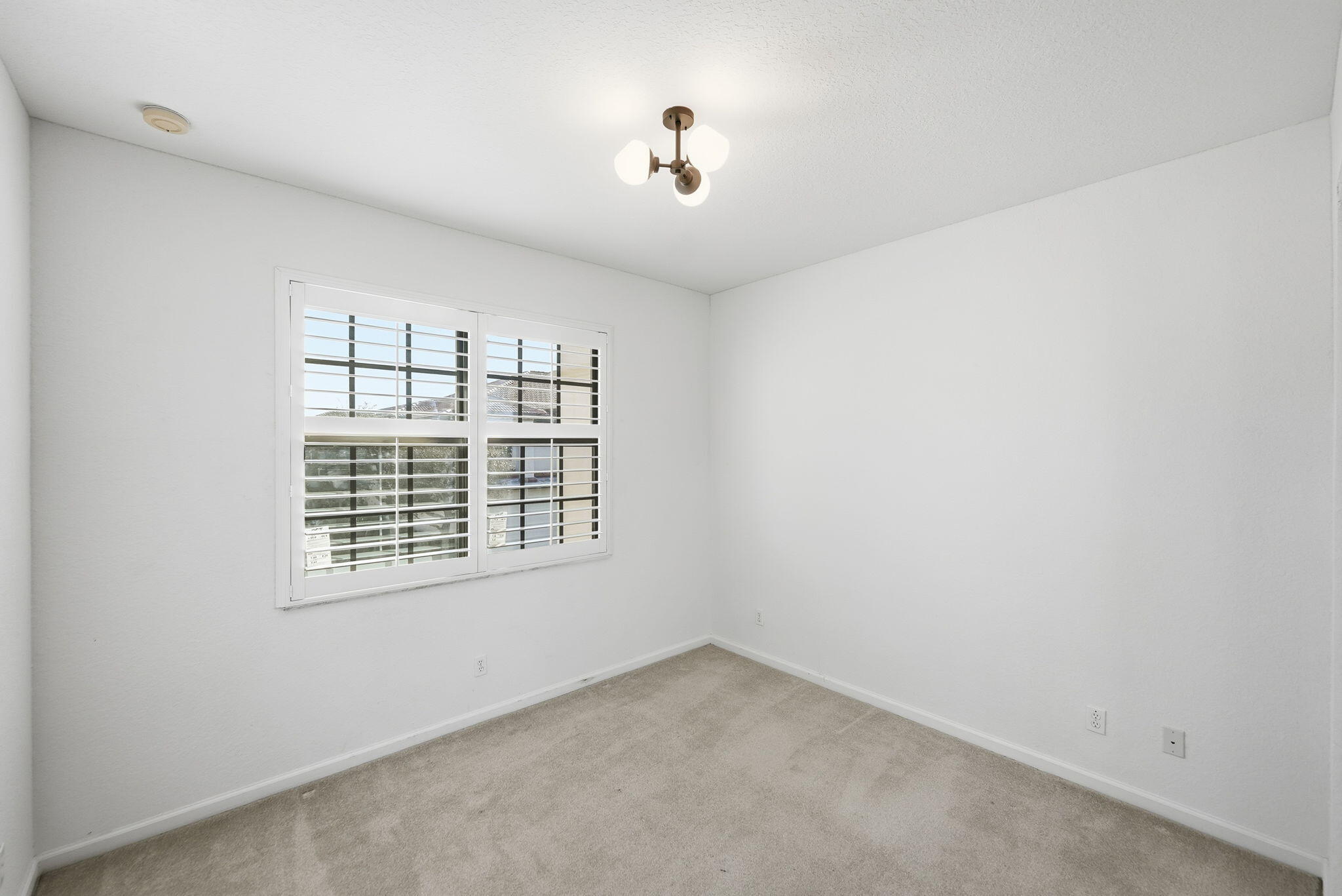 6675 Southeast Woodmill Pond Lane Stuart, FL 34997 - Photo 36 of 61 a view of an empty room with a window