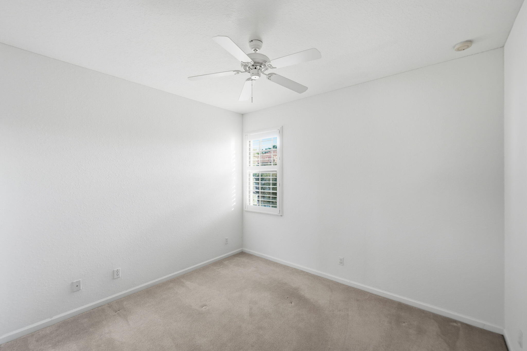 6675 Southeast Woodmill Pond Lane Stuart, FL 34997 - Photo 38 of 61 an empty room with a window and a fan