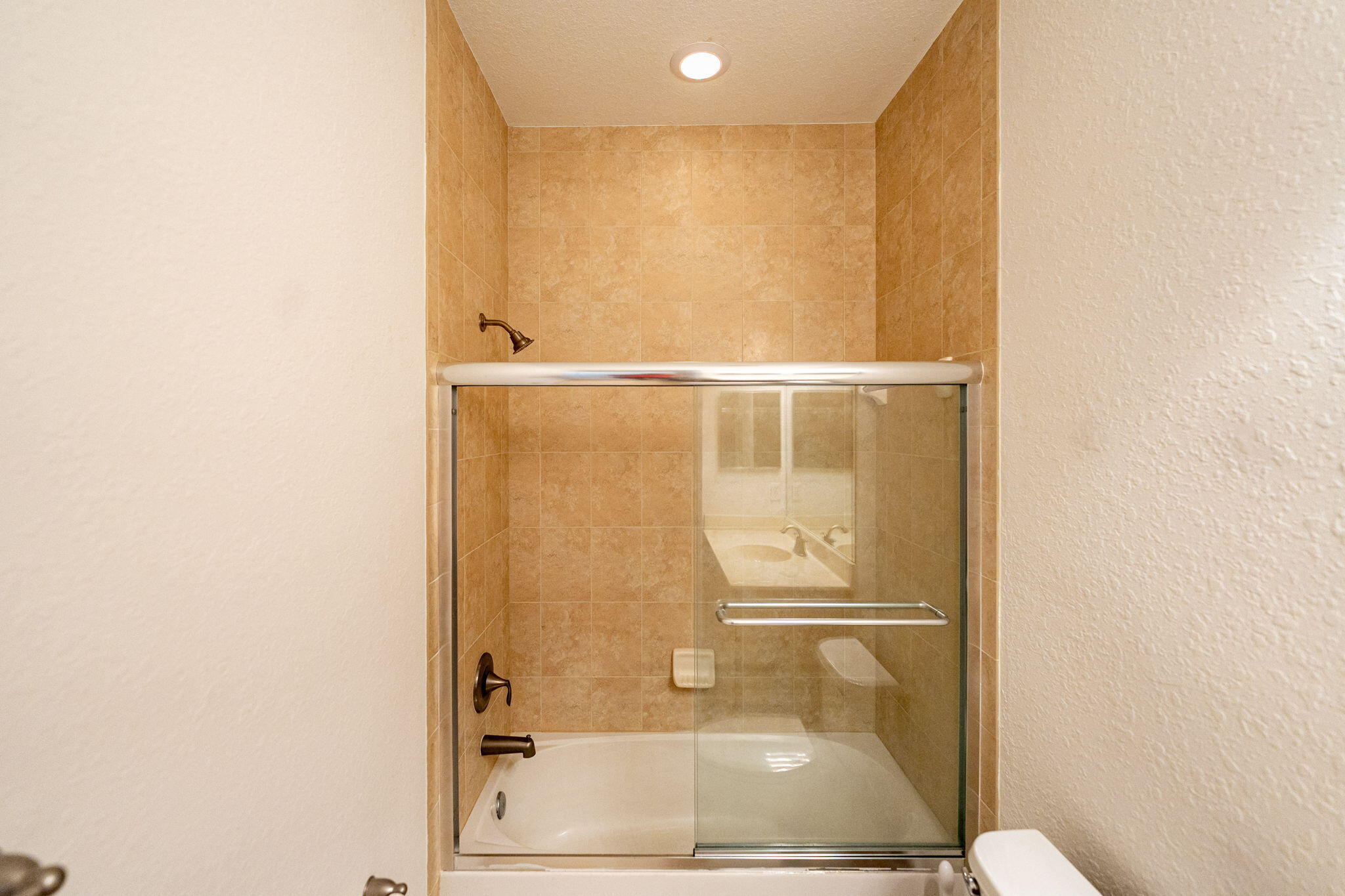 6675 Southeast Woodmill Pond Lane Stuart, FL 34997 - Photo 40 of 61 a bathroom with a glass shower door