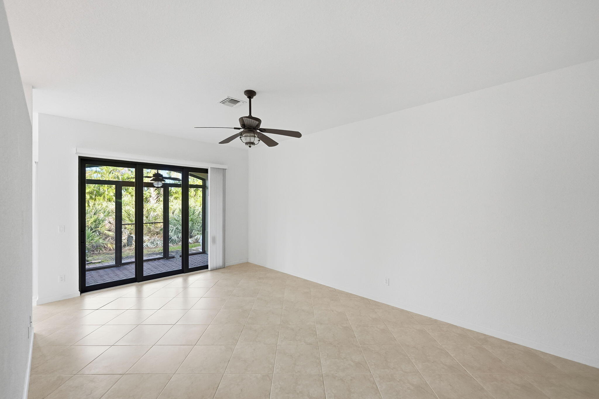 6675 Southeast Woodmill Pond Lane Stuart, FL 34997 - Photo 5 of 61 a view of an empty room with a window