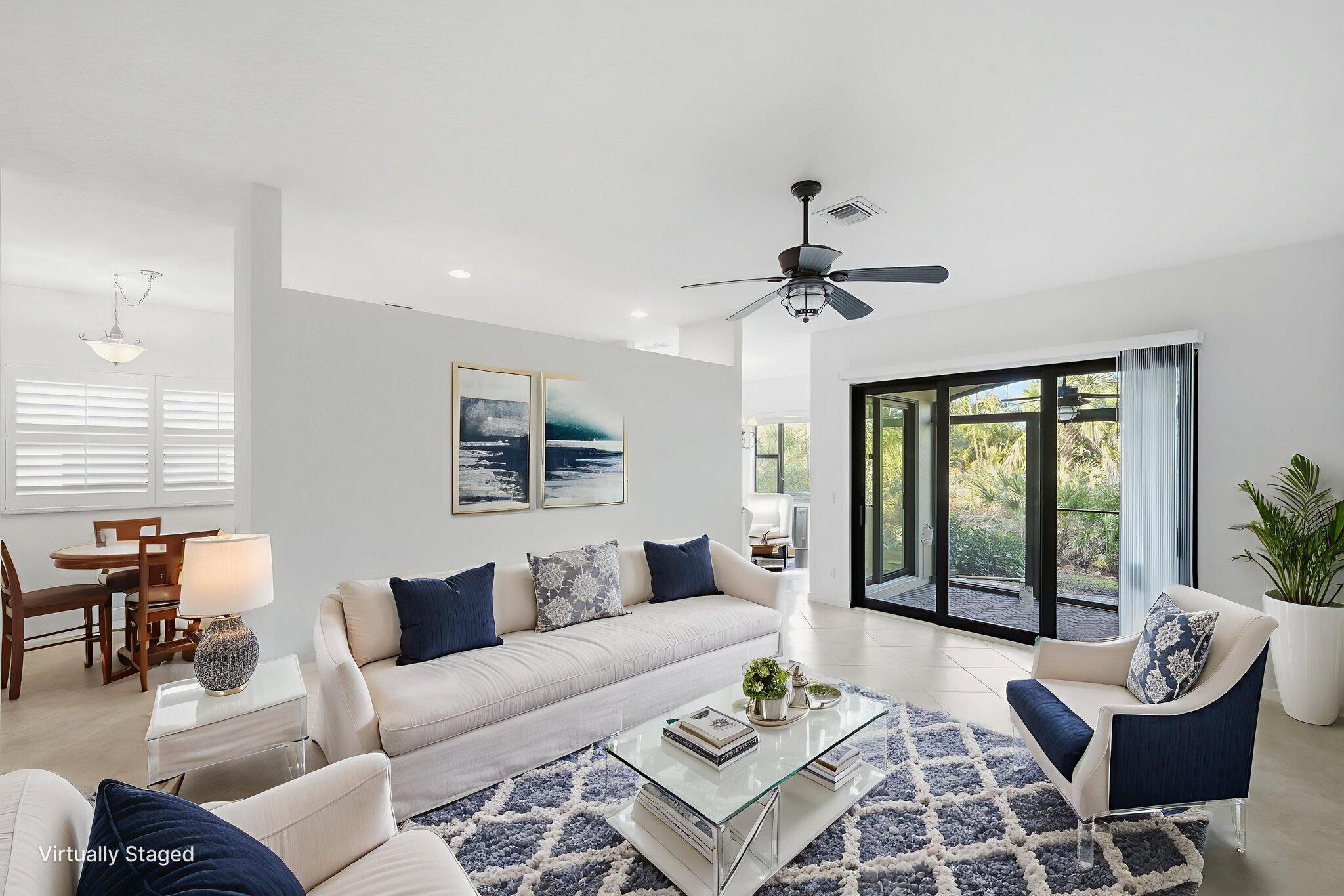 6675 Southeast Woodmill Pond Lane Stuart, FL 34997 - Photo 8 of 61 a living room with furniture and a large window