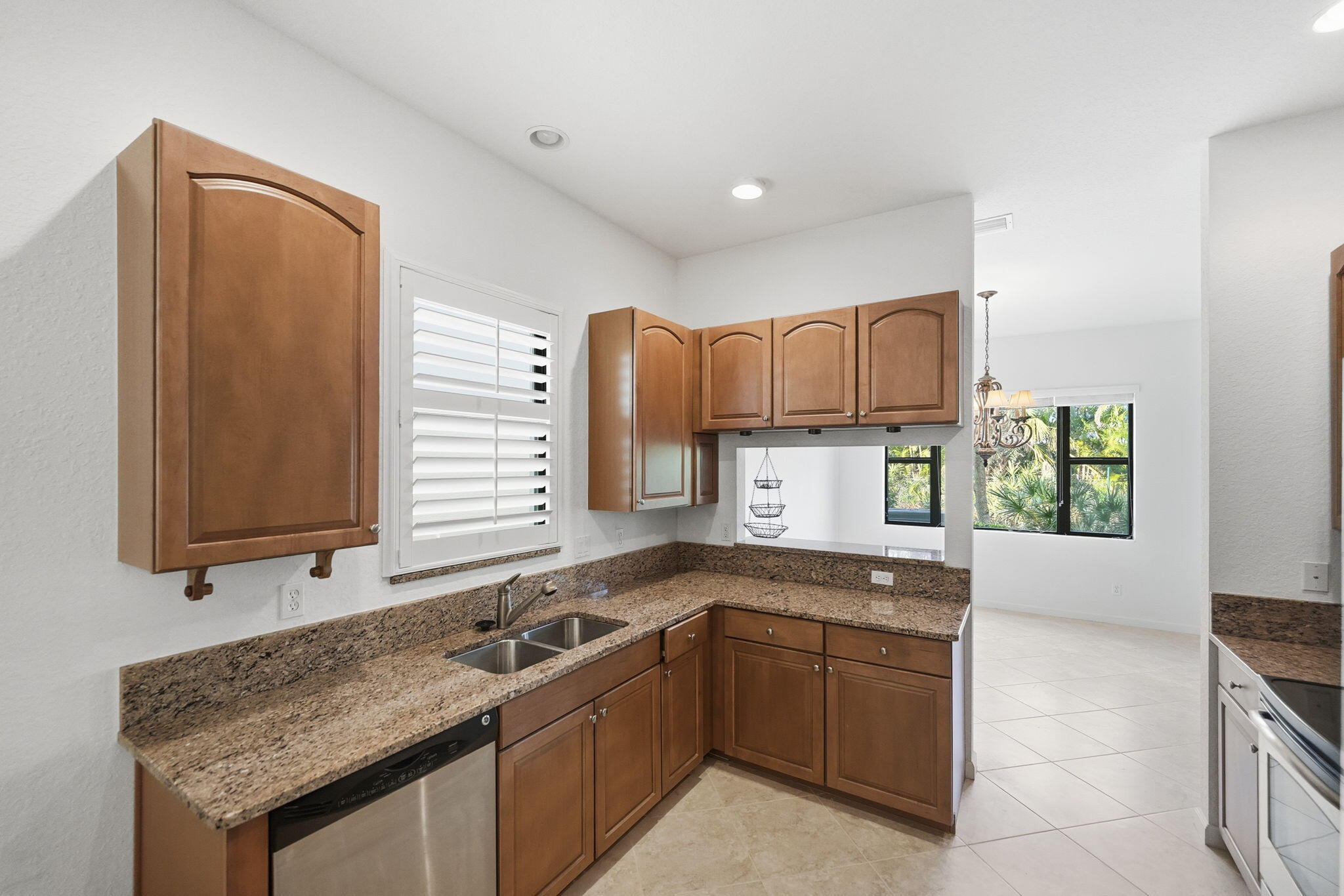 6675 Southeast Woodmill Pond Lane Stuart, FL 34997 - Photo 10 of 61 a kitchen with a sink stove and cabinets