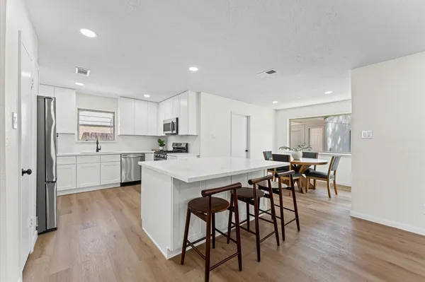 a kitchen with a table and chairs in it