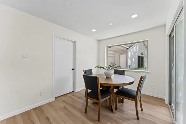 a view of a dining room with furniture and window