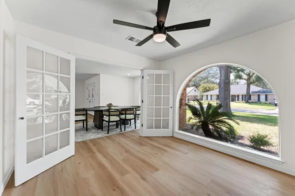 wooden floor with a lot of furniture and a large window