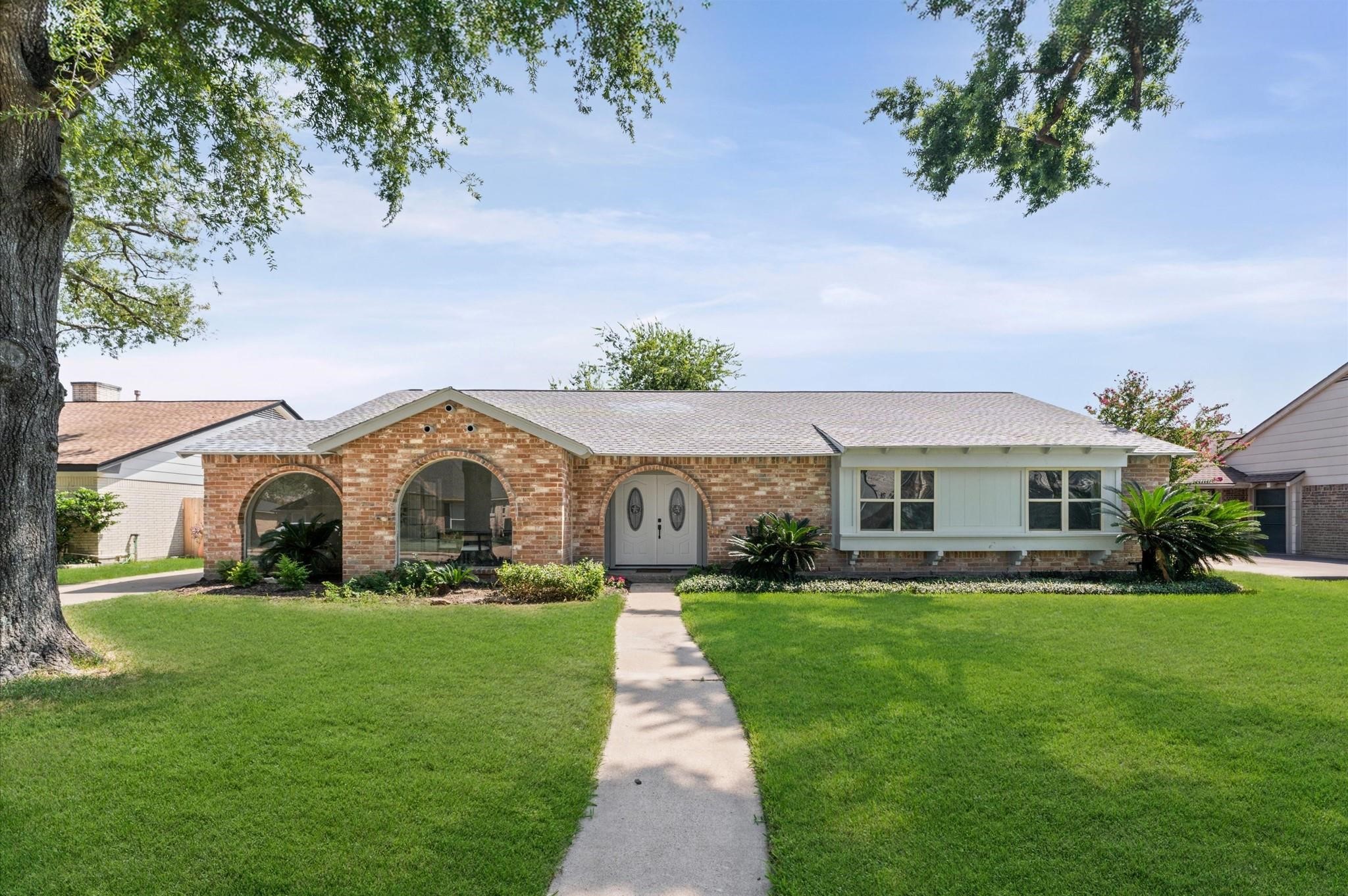 2914 Riata Lane Houston, TX 77043 - Photo 2 of 44 a front view of a house with a yard and potted plants