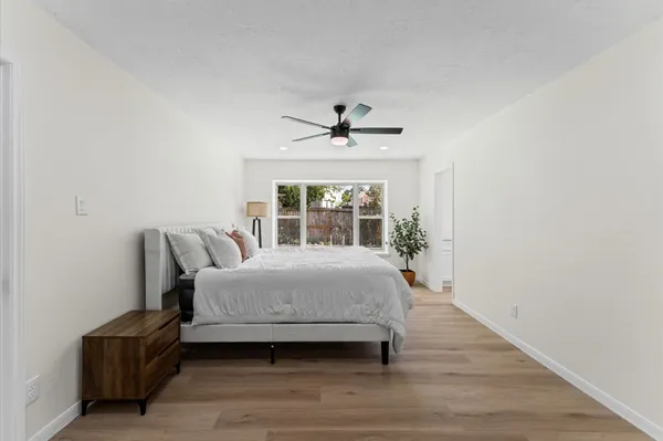a spacious bedroom with a bed and a window