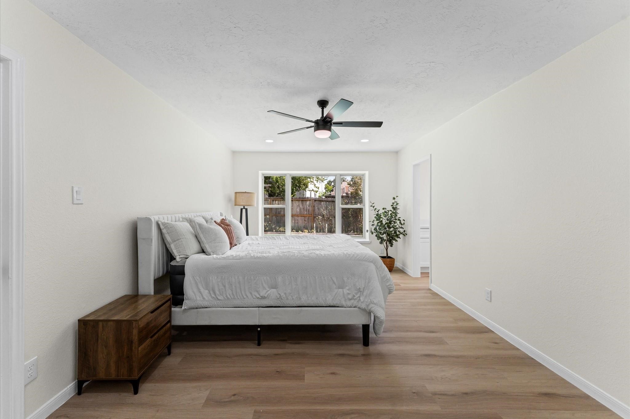 2914 Riata Lane Houston, TX 77043 - Photo 22 of 44 a spacious bedroom with a bed and a window