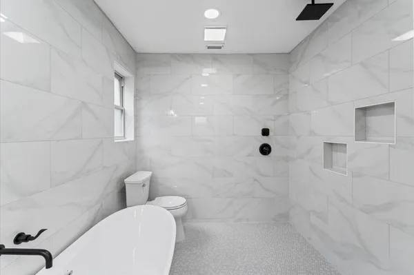 a bathroom with a toilet and shower